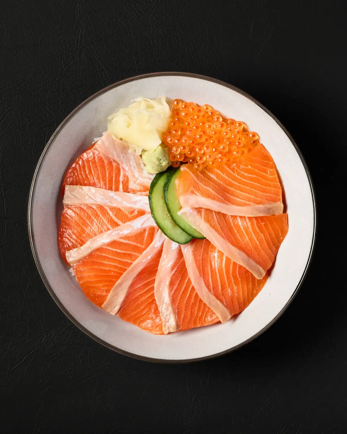 Salmon slices and roe arranged over a rice bowl at Kuza Urban Japanese Food.