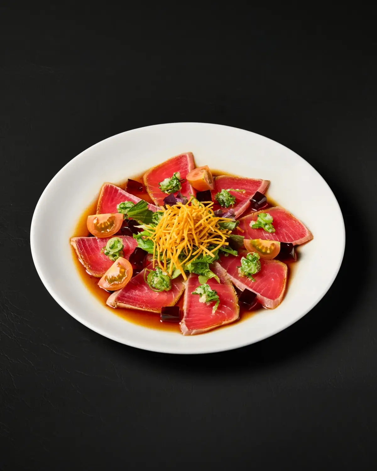 Sliced fish arranged around a colourful salad garnish at Kuza Urban Japanese Food.