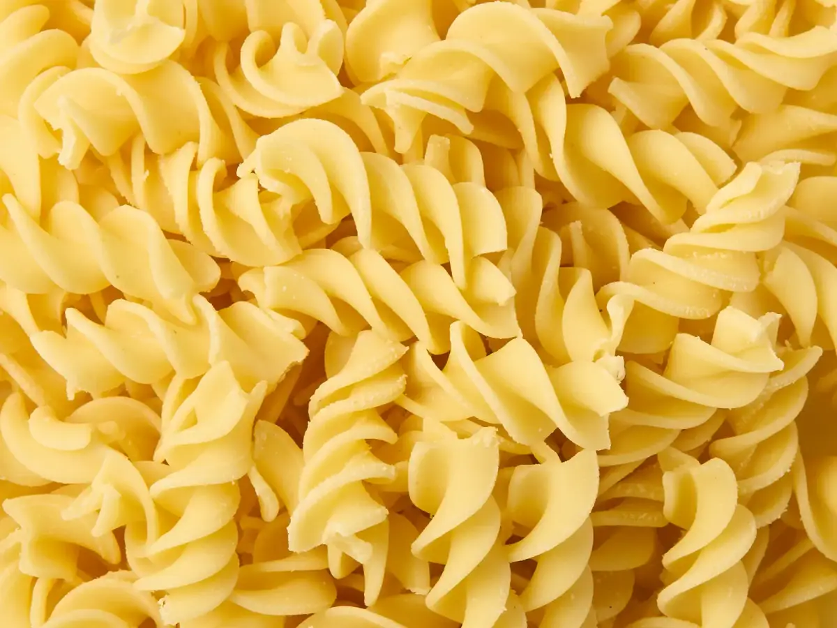 Overhead close-up of fresh La Delizia Lab fusilli spirals showing the bronze-die texture of the pasta