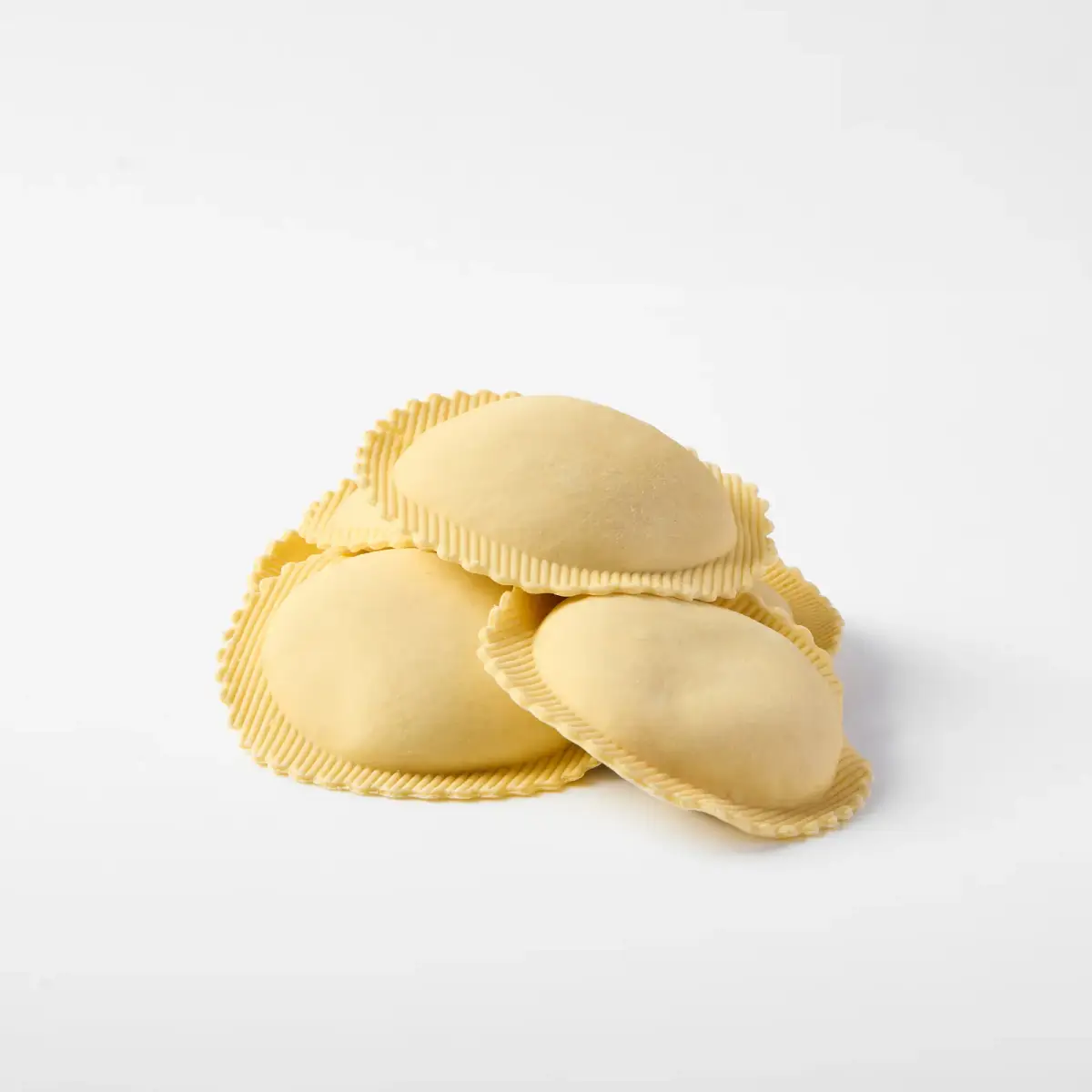 Fresh La Delizia Lab lobster and prawn agnolotti stacked and photographed on a clean white background