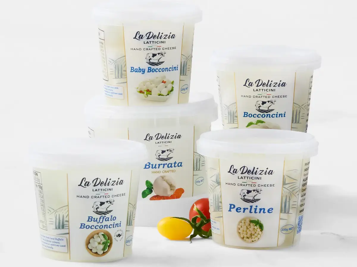 La Delizia Latticini retail cheese tubs including Baby Bocconcini, Bocconcini, Burrata, Buffalo Bocconcini, and Perline with fresh tomato