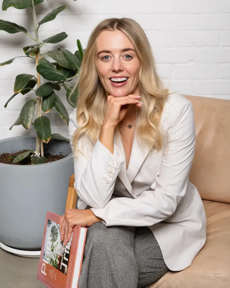Perth author seated with her book during a personal-branding portrait session.