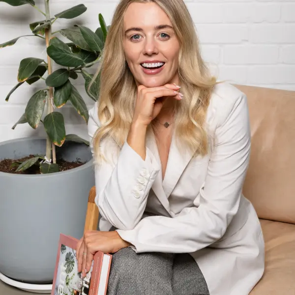Perth author seated with her book during a personal-branding portrait session.