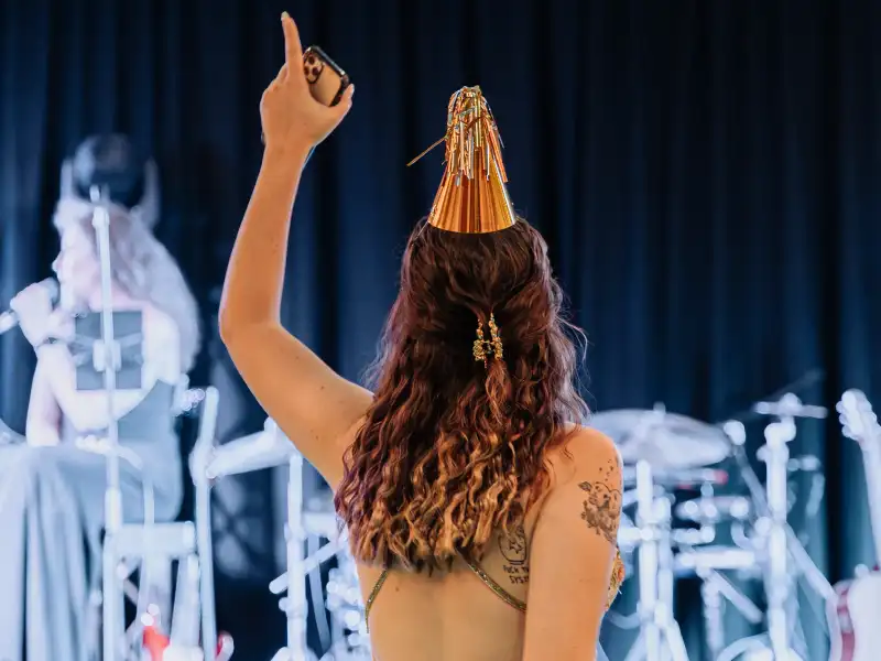 Live band performing at a Perth party while a guest celebrates, showing the kind of event moment photography captures differently to video