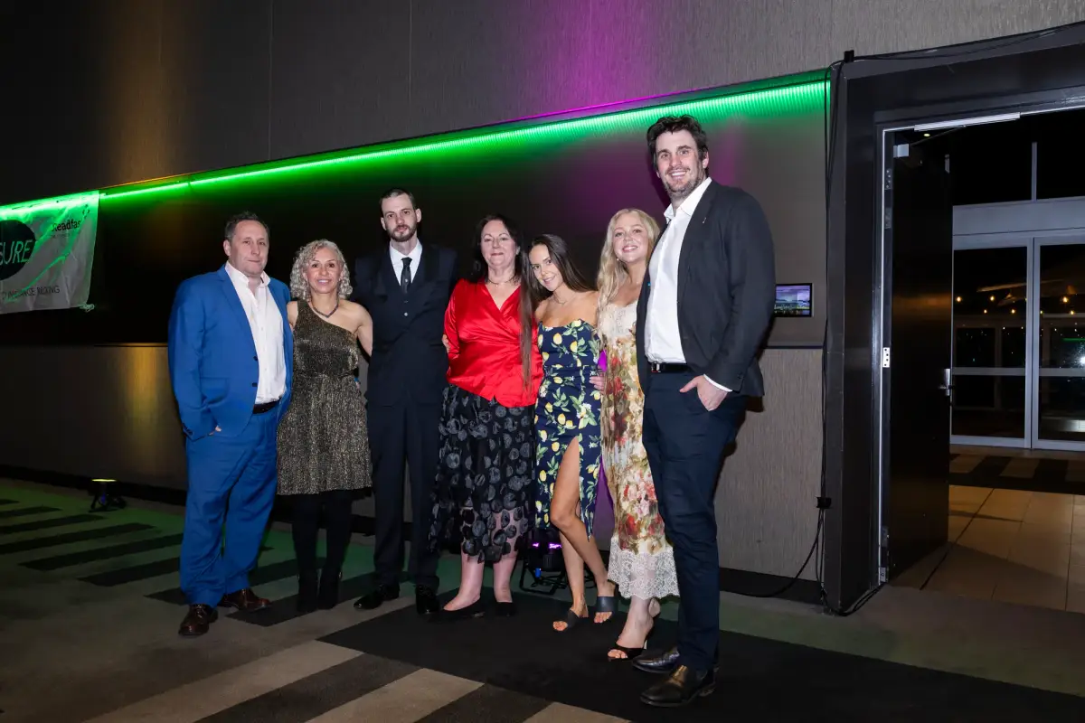 Guests posing for a group portrait at the gala dinner at LRTAWA Corporate Event.