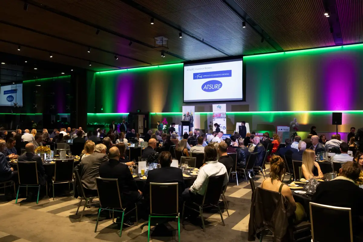 Gala dinner room with green and purple lighting at LRTAWA Corporate Event.