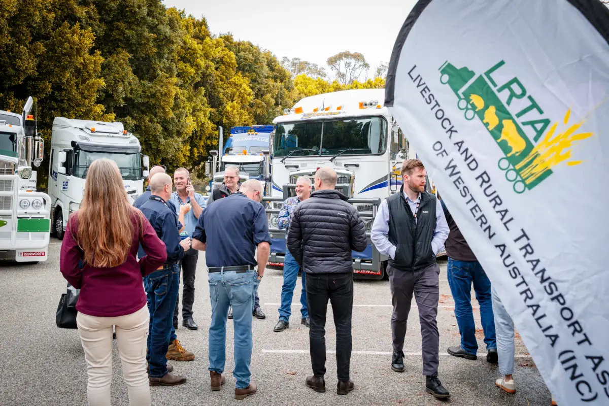 Attendees beside an LRTAWA flag and outdoor truck display at LRTAWA Corporate Event.