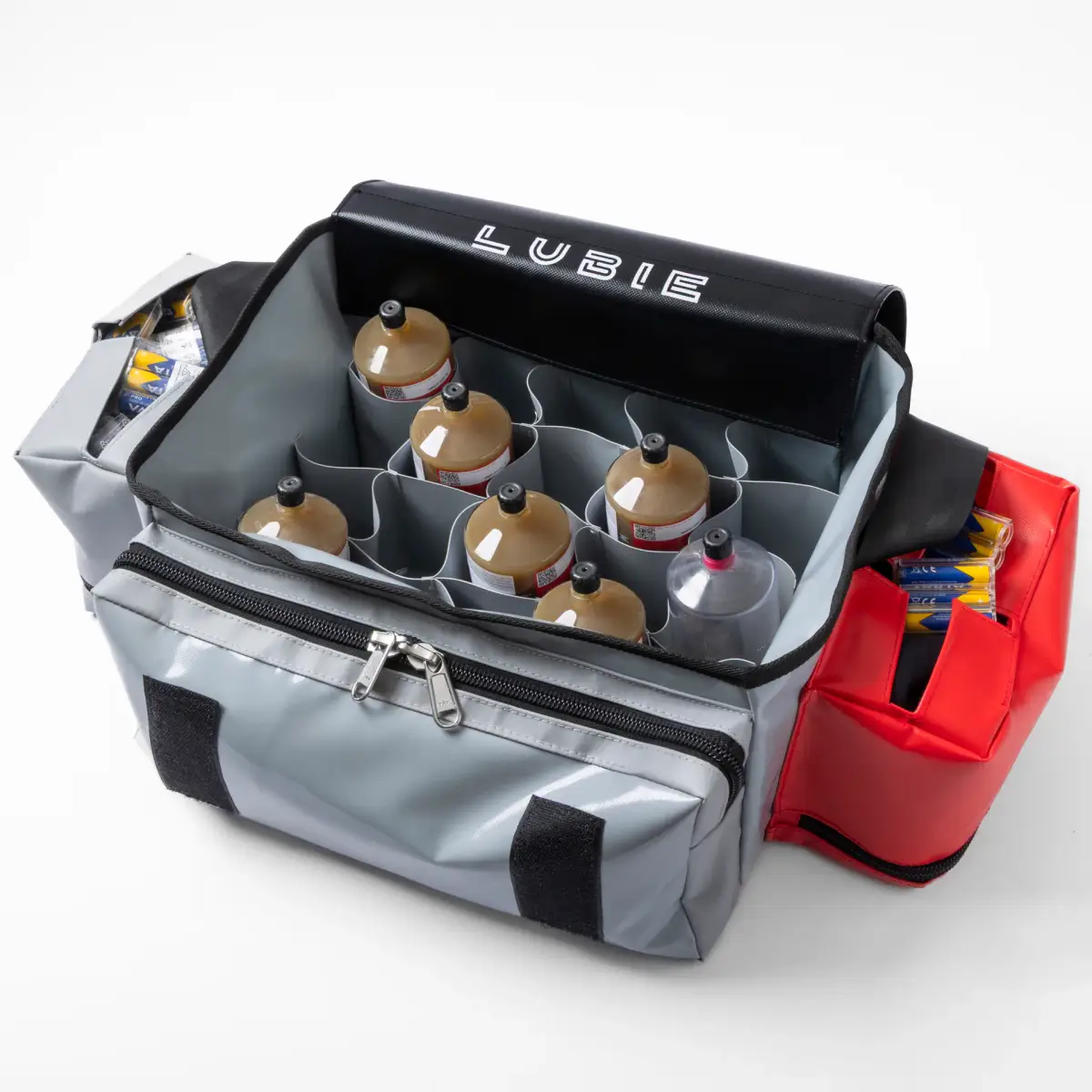Open Lubie SPL 250 maintenance bag loaded with lubricant cartridges and batteries in dedicated compartments