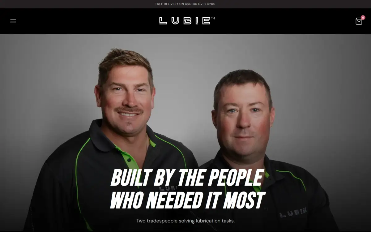 Lubie website About page with a portrait of the two founders in branded work shirts under the headline Built by the people who needed it most