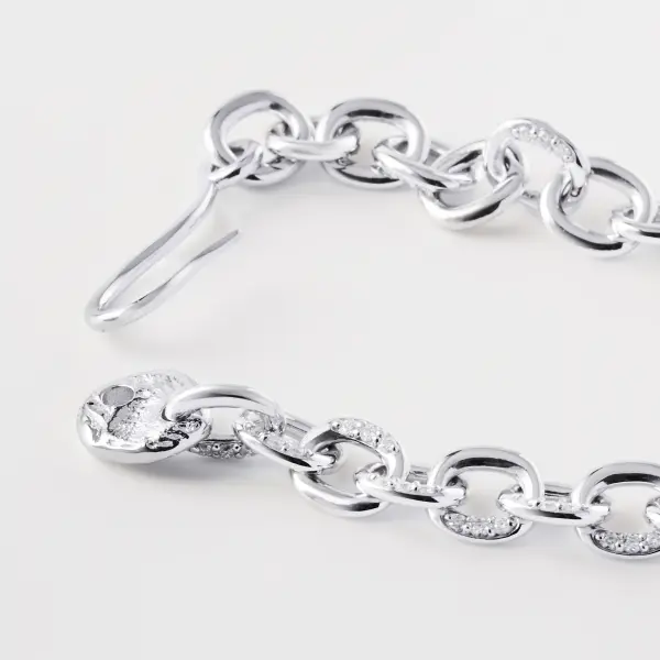 Close-up of a silver diamond-link bracelet showing polished links and clasp construction.