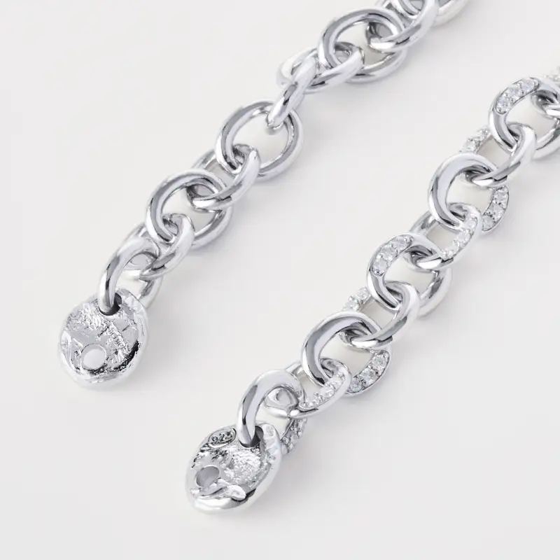 Layered silver chain bracelets photographed together to show scale and link variation.