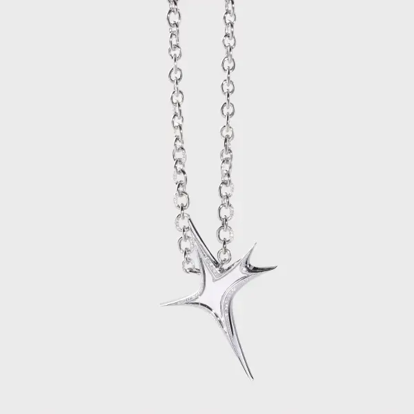 Close-up of a silver diamond-set star pendant and chain showing polished metal detail.