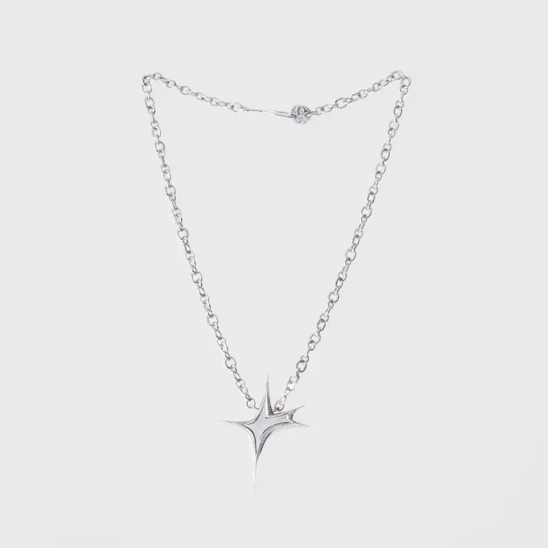Silver diamond-set star pendant necklace photographed on a clean light background.