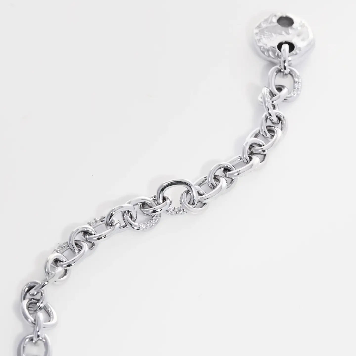 Fine silver diamond necklace photographed close up to show chain links and reflective finish.