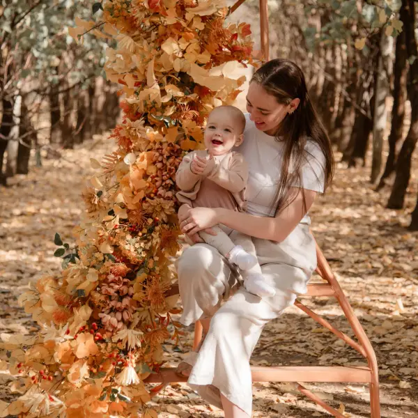 Mother and baby portrait photographed in an autumn setting.