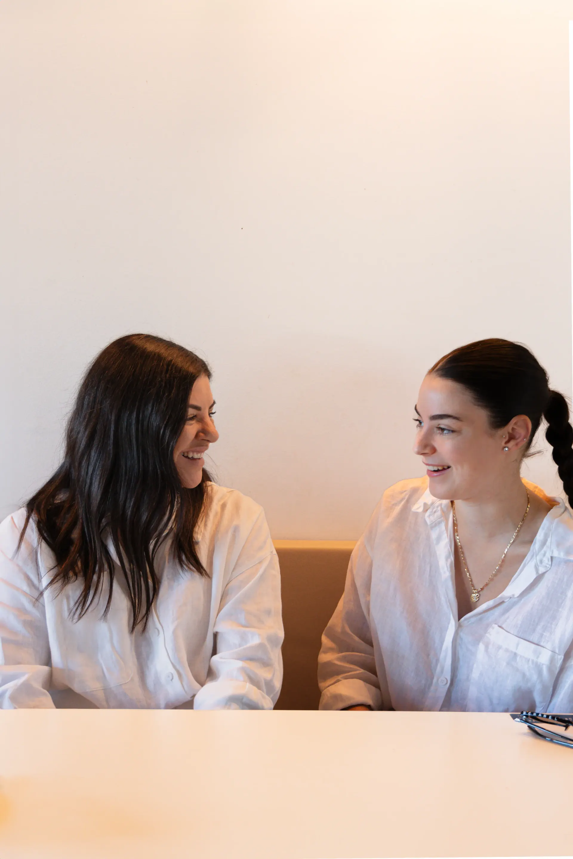 Two women photographed together with natural expressions during a Perth portrait session.