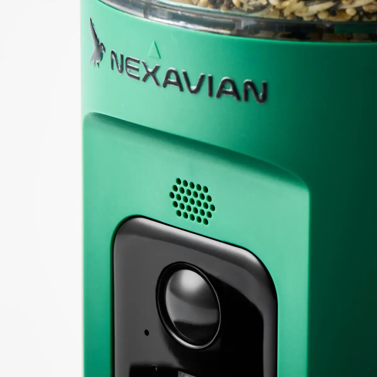 Close-up of the Nexavian logo, speaker openings and black camera module on the green bird feeder housing