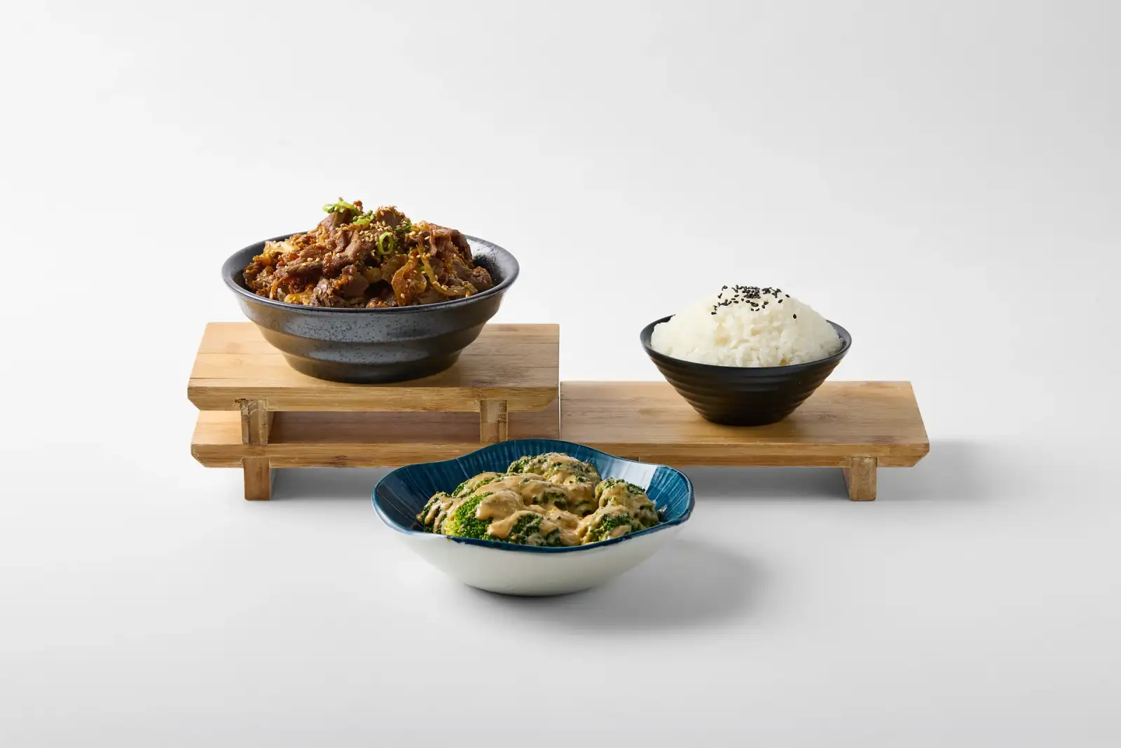White-background menu spread for Omasa Japanese Restaurant showing a beef donburi bowl with rice, broccoli, and supporting dishes arranged on timber risers