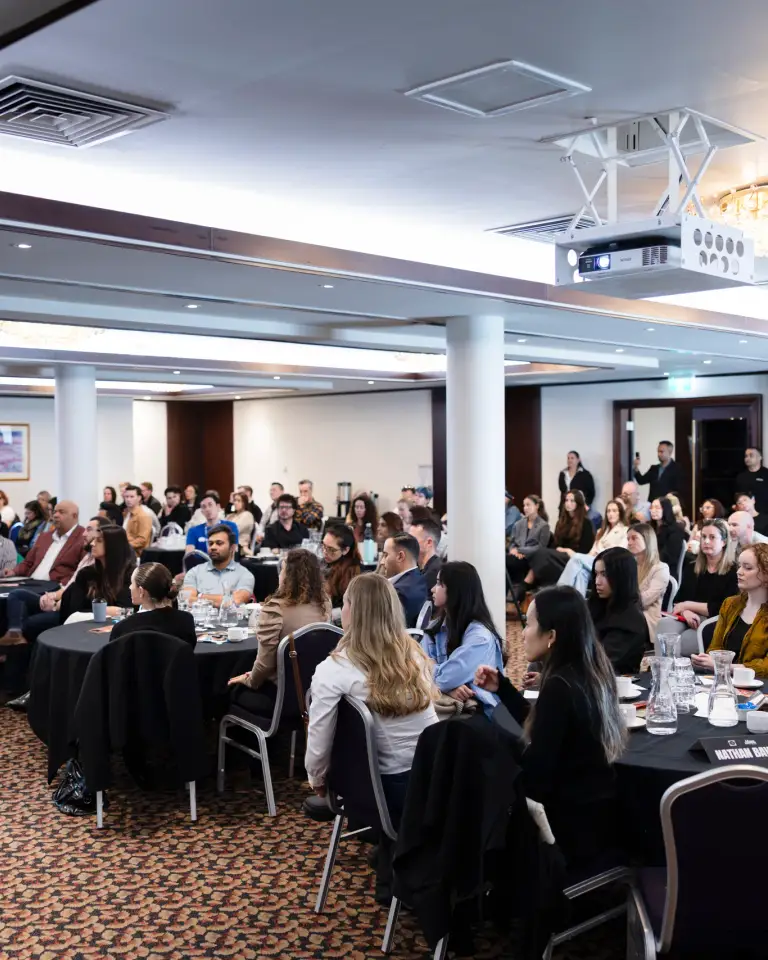 Conference delegates seated for a corporate presentation in Perth.