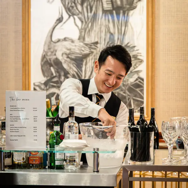 A bartender serving an event bar photographed for catering photography in Perth.