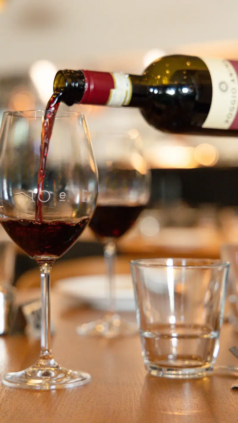 A wine service moment photographed for bar photography in Perth.