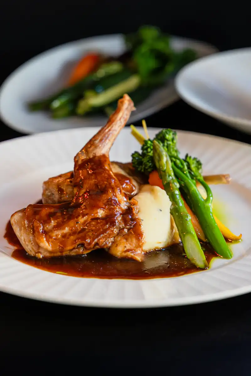 Modern Perth restaurant website displayed on laptop and mobile devices showing fast loading speed and booking integration.