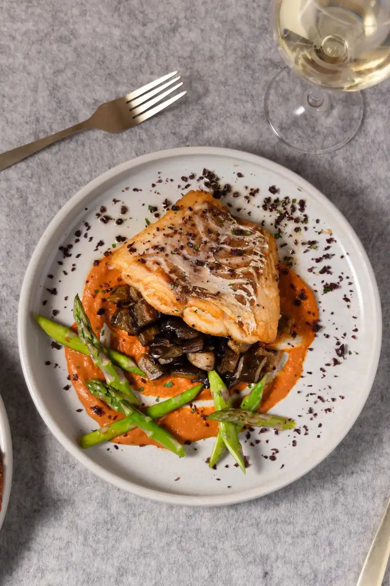 Side-by-side comparison of food photography using natural window light versus professional LED lighting in a Perth café setting.