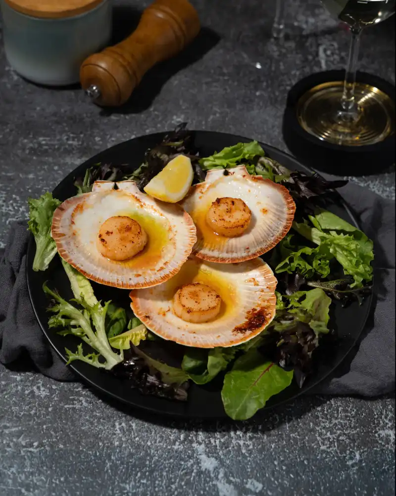 Seared scallops plated by a Perth fine dining kitchen, captured by a professional food photography agency