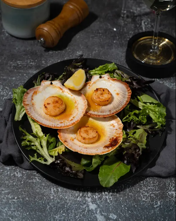 Seared scallops with garnish, fine dining menu photography for Perth restaurants.