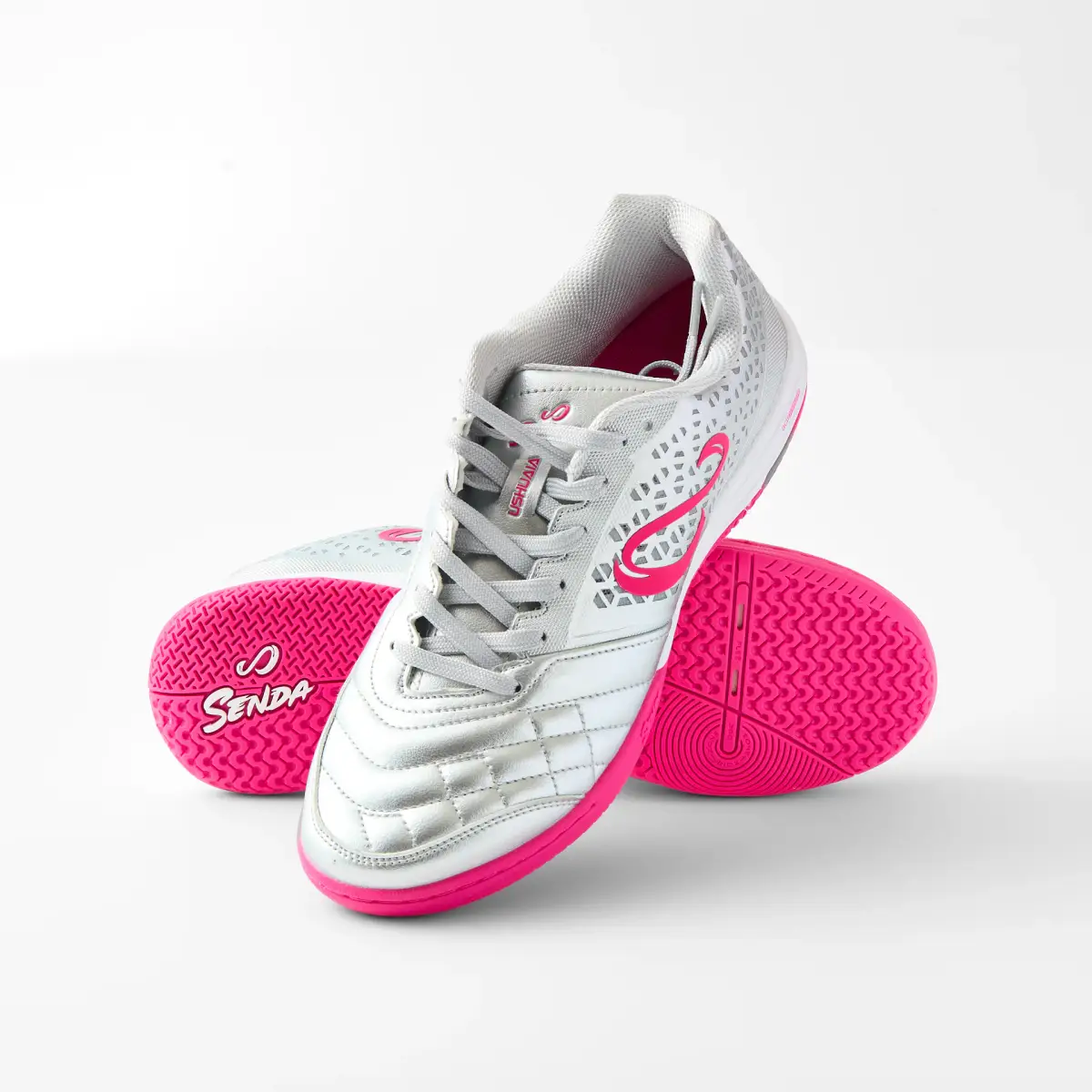 Silver and pink Senda Ushuaia futsal shoes arranged to show the upper and bright pink sole on white