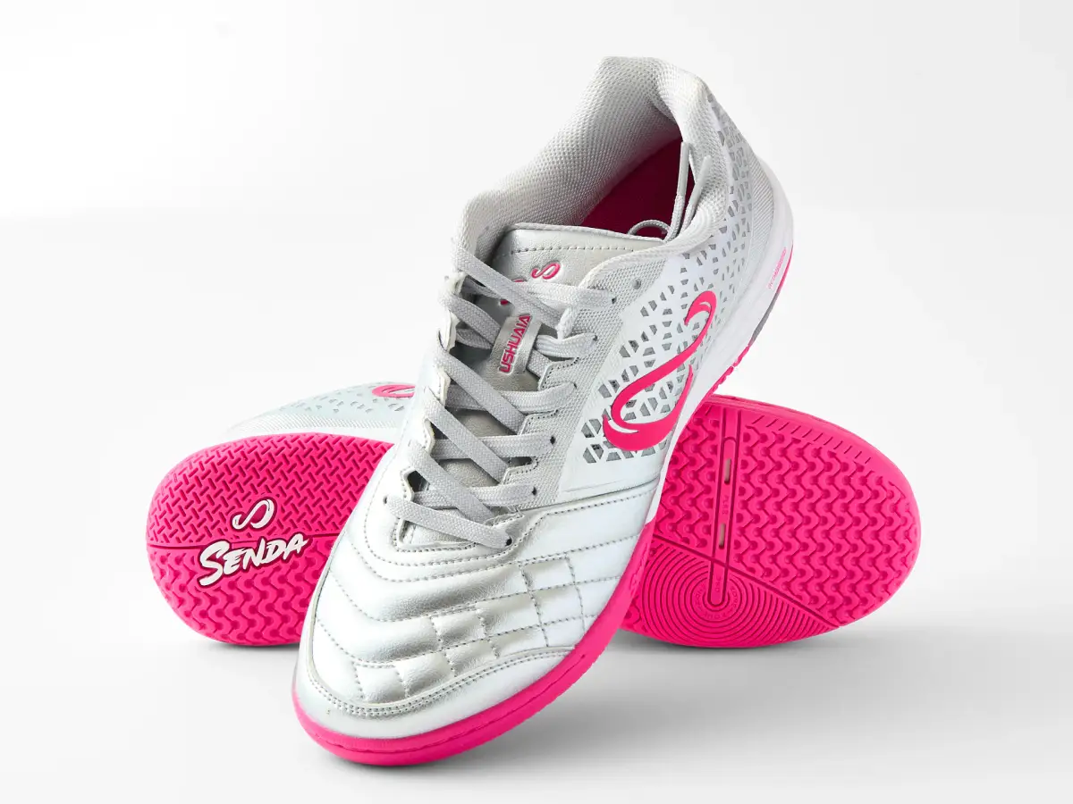 Silver and pink Senda Ushuaia futsal shoes arranged to show the upper and bright pink sole on white