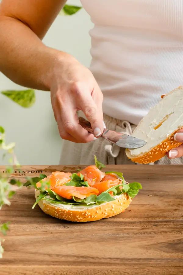 Smoked salmon bagel with fresh garnish, brunch photography for Perth cafes.