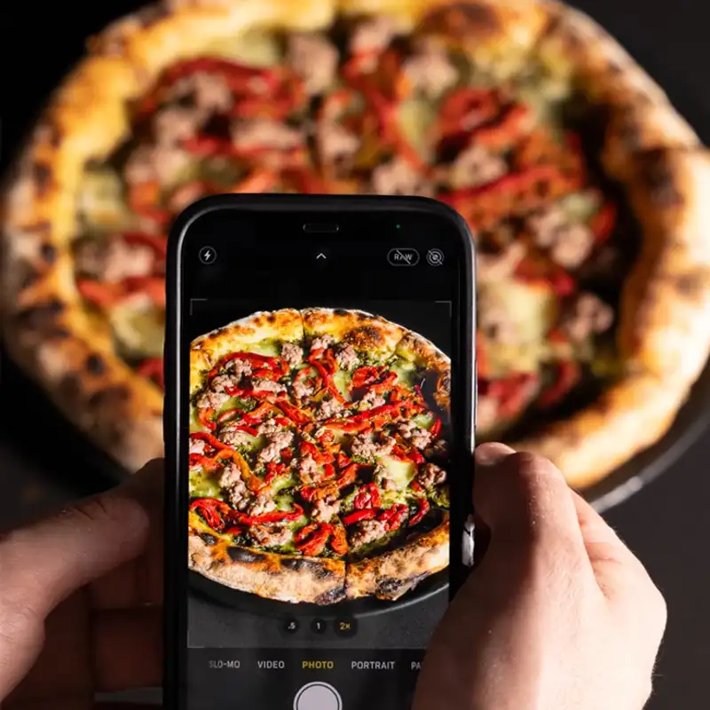 Behind-the-scenes of smartphone food photography, showcasing content creation services for Perth restaurant marketing.