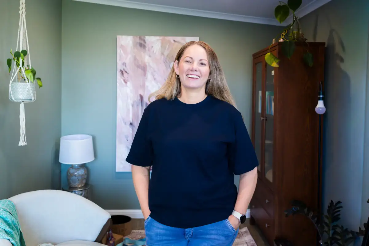 Stroke survivor Karla standing confidently in her home during a charity campaign photography session