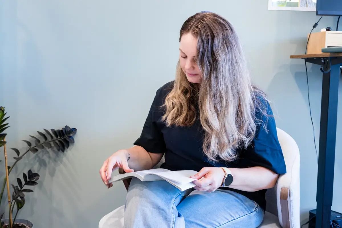 Stroke survivor Karla reading at home in natural light for the Stroke Foundation August Appeal