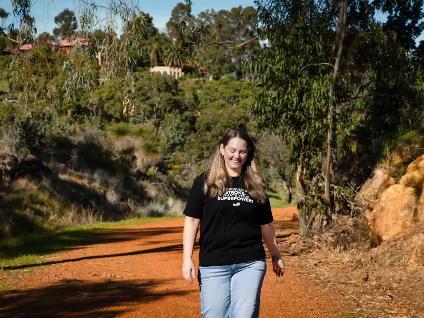 Stroke survivor Karla walking confidently along an Australian bush pathway for the Stroke Foundation appeal campaign