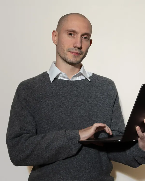 Stefano, lead web developer in Perth holding a laptop, specializing in high-performance Astro and custom-coded websites.