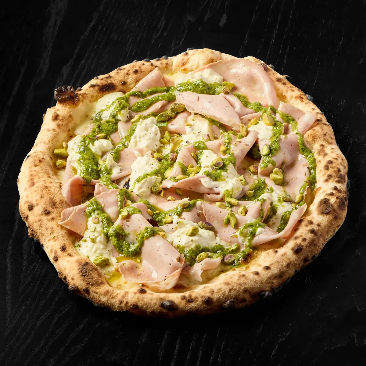 Artisan pizza topped with premium Italian mortadella, fresh burrata stracciatella, and crushed pistachio crumb