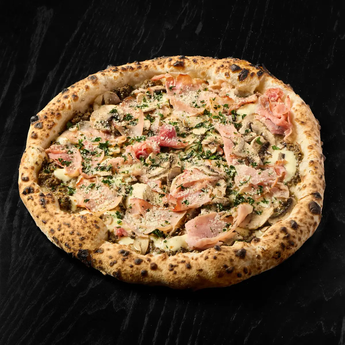 Top-down view of truffle and mushroom gourmet pizza with seasoned herbs and blistered edges