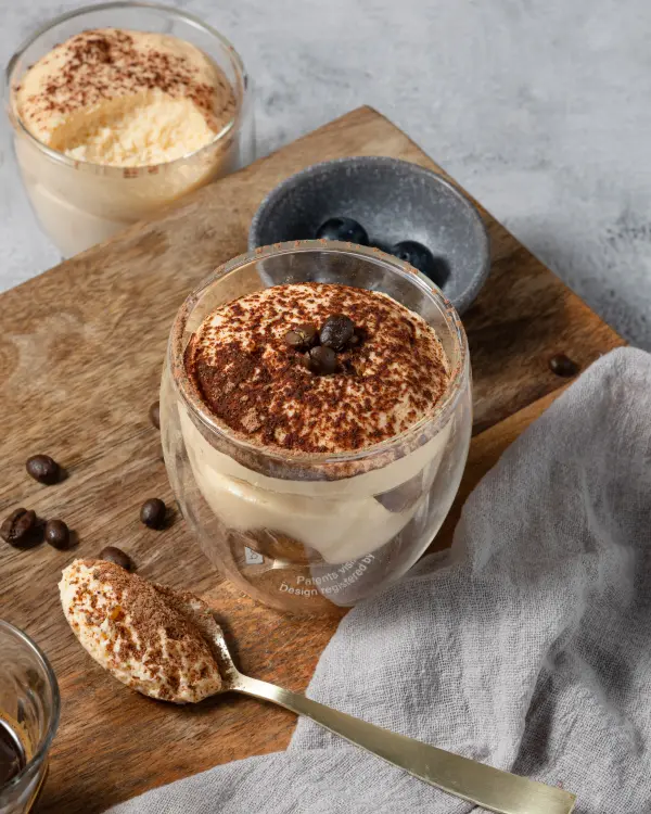 Tiramisu served in a glass cup, cafe dessert photography by Amplify Creative Lab in Perth.