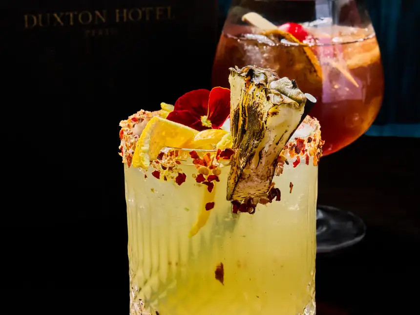Two signature cocktails photographed for T.O.T.O Bar in Perth CBD with dark bar styling and premium garnish details