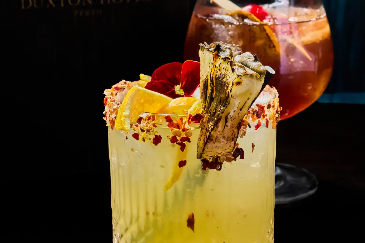 Two signature cocktails photographed for T.O.T.O Bar in Perth CBD with dark bar styling and premium garnish details
