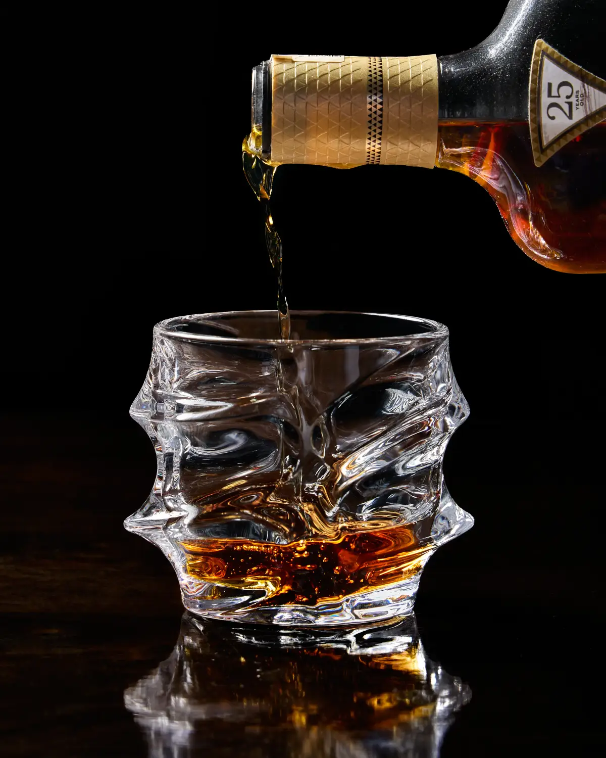 Whisky being poured into a crystal glass for premium drinks photography at T.O.T.O Bar