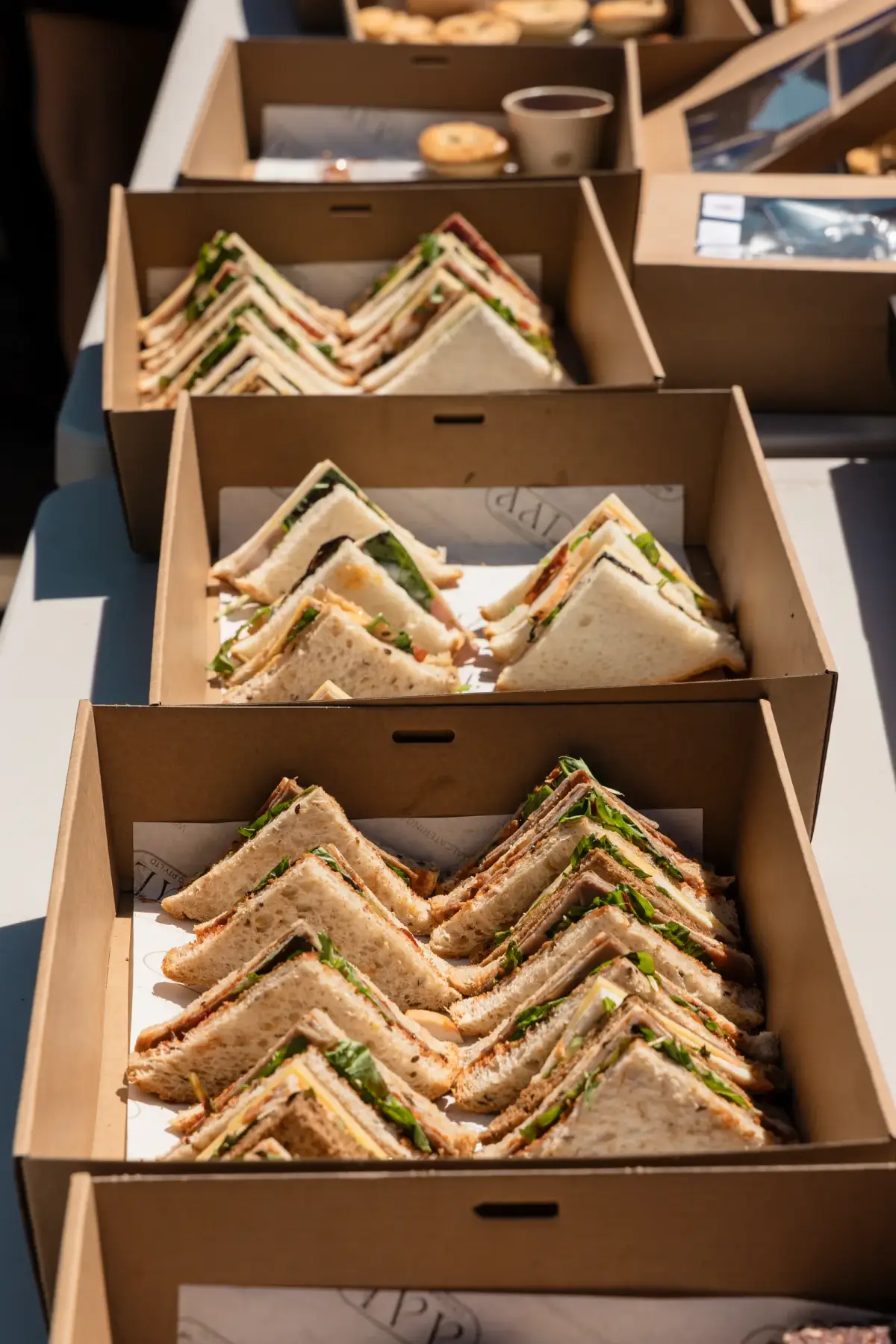 Close-up of boxed sandwiches laid out for catering at the Vera Living event