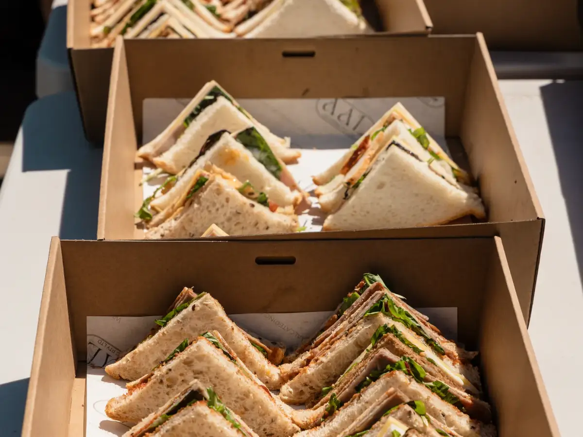 Close-up of boxed sandwiches laid out for catering at the Vera Living event