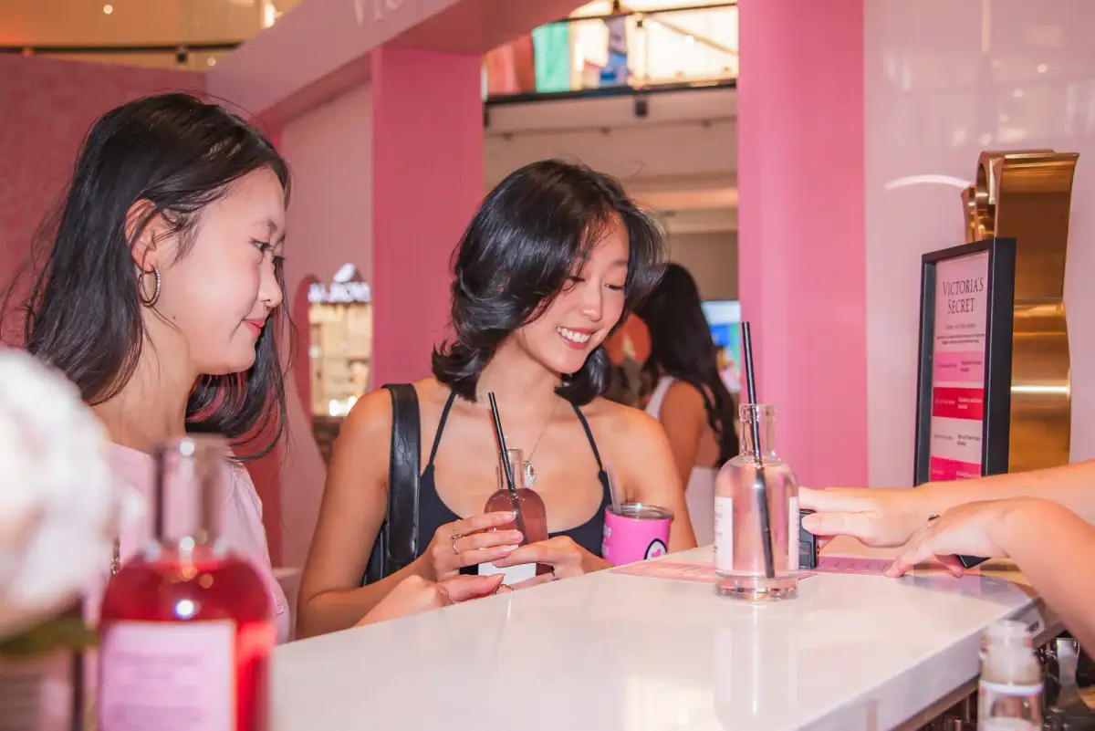 Guests sampling fragrances at the pink counter inside the new Victoria's Secret store at Karrinyup