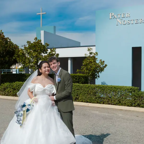 Wedding couple standing together outside the church after their Perth ceremony.