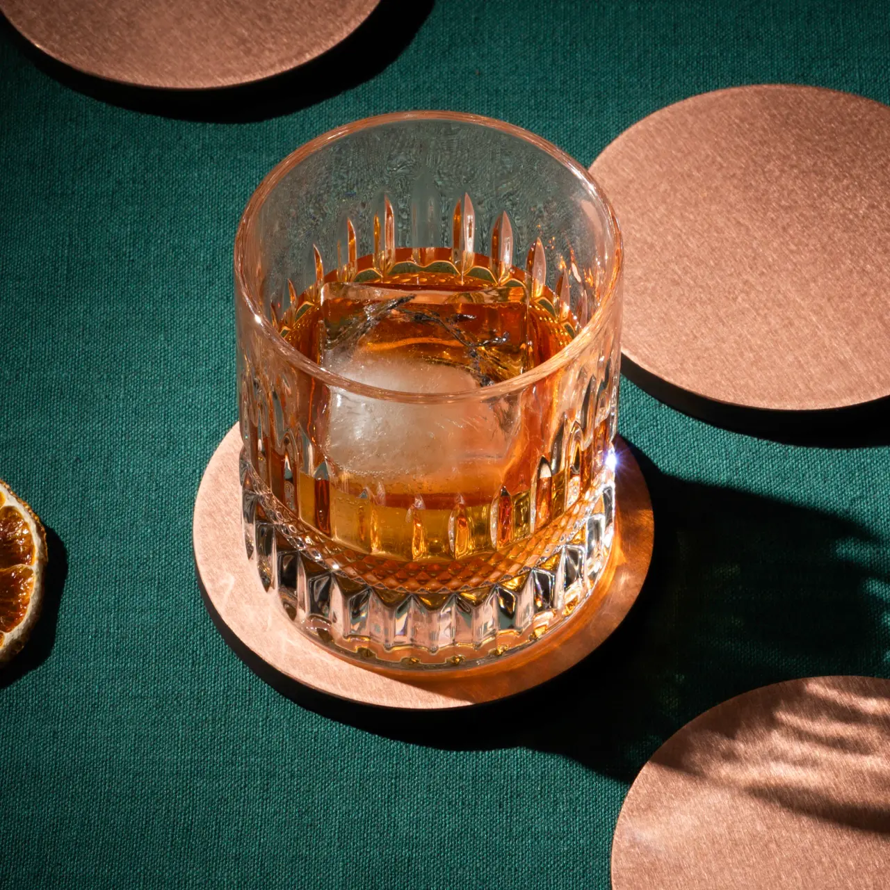 Whisky glass on a metallic coaster in a styled scene for supporting Amazon lifestyle imagery