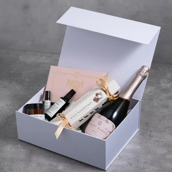 White skincare gift hamper styled with rose details for a beauty launch.