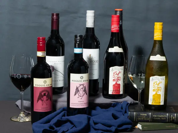 Editorial lineup of wine bottles on blue fabric, wine label and product photography for Perth wineries.